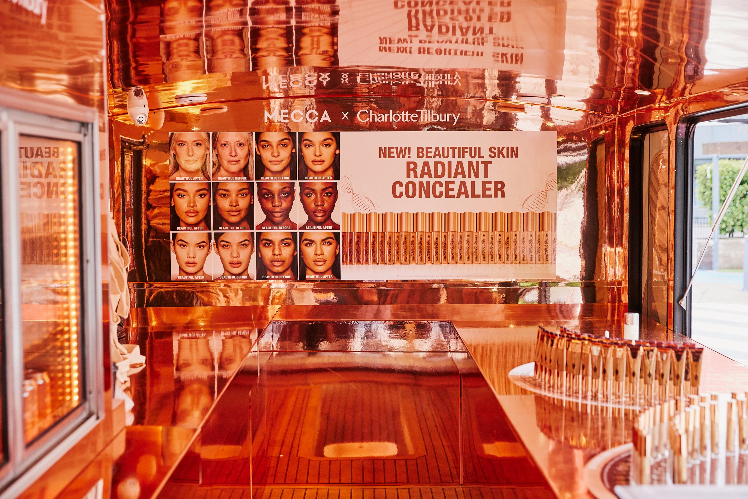 Illuminated Charlotte Tilbury product wall inside the MECCA bus
